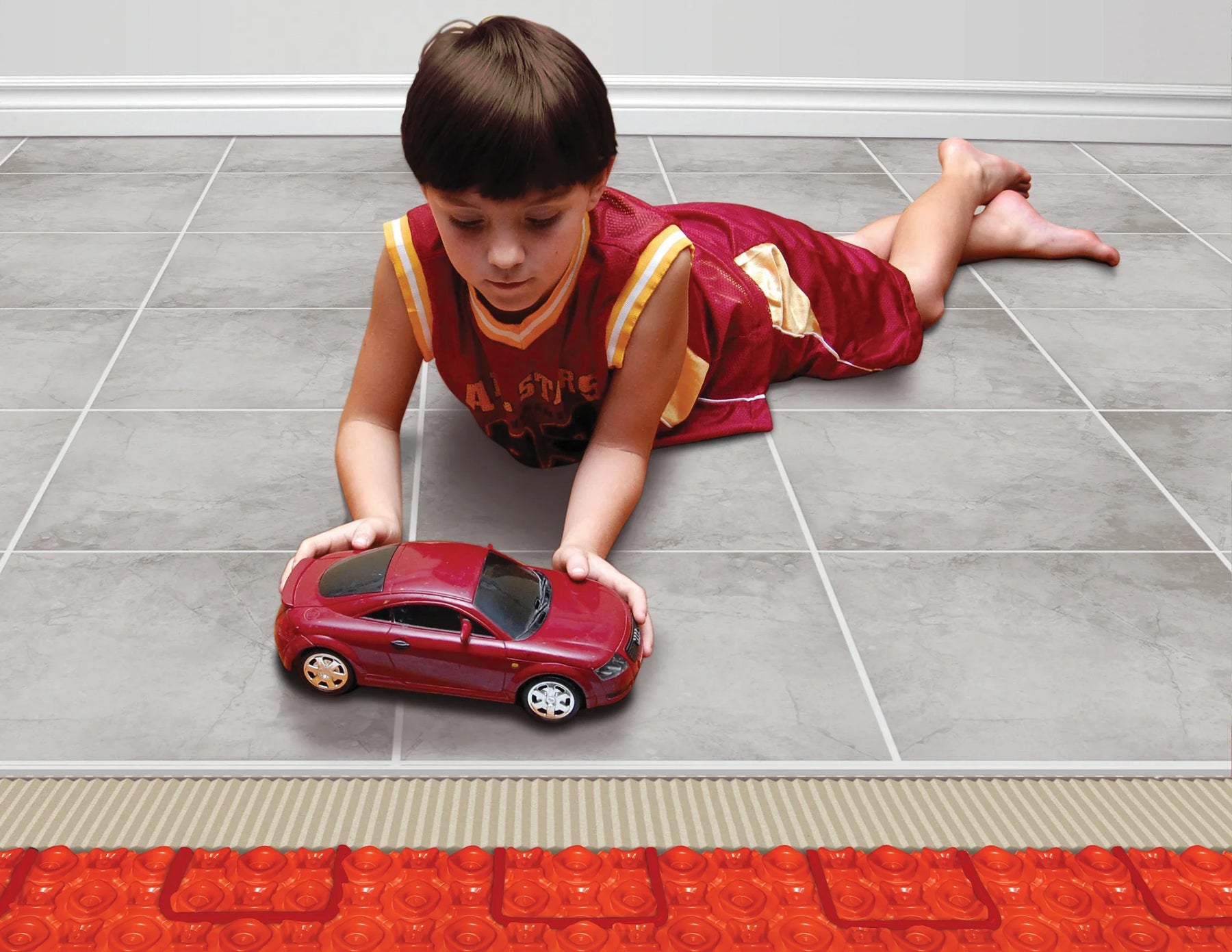 Boy playing on heated tile floor