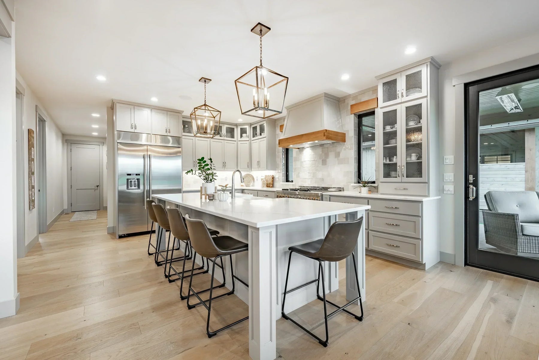 Modern kitchen with island seating and pendant lighting featuring a heated kitchen floor and underfloor heating kitchen system.