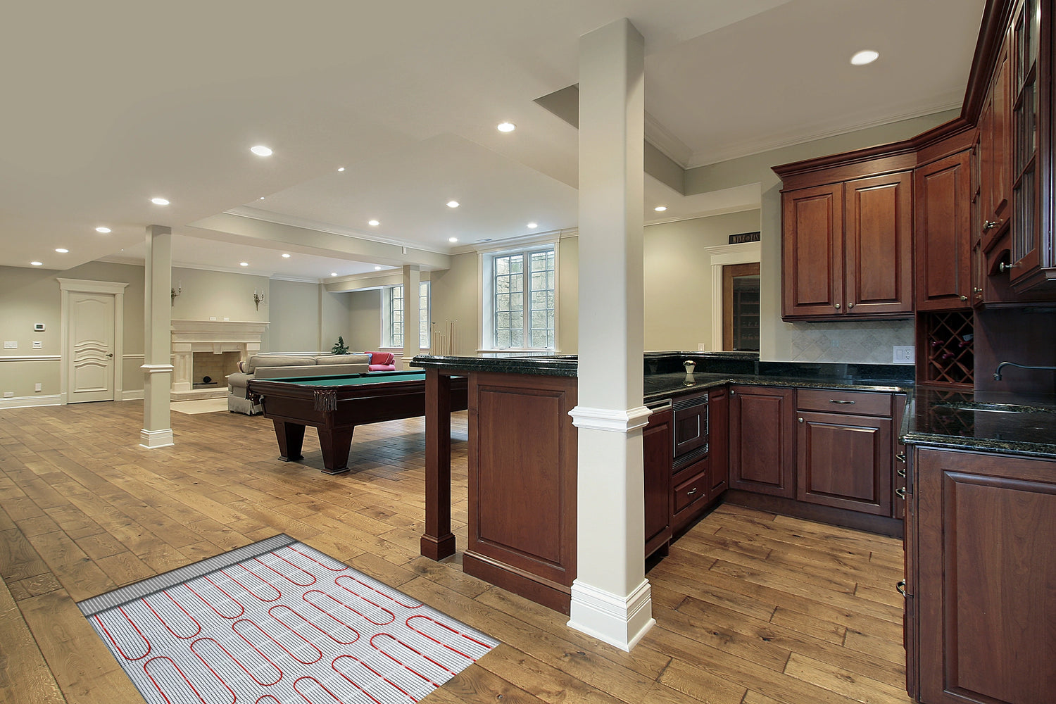 Luxury basement entertainment area with electric floor heating installed under laminate floor