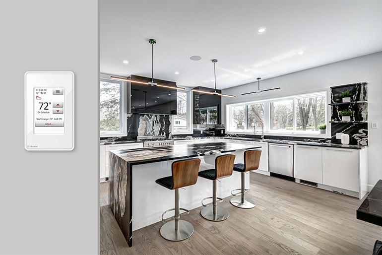 Modern kitchen with floor heating installed and a floor heating thermostat on the wall