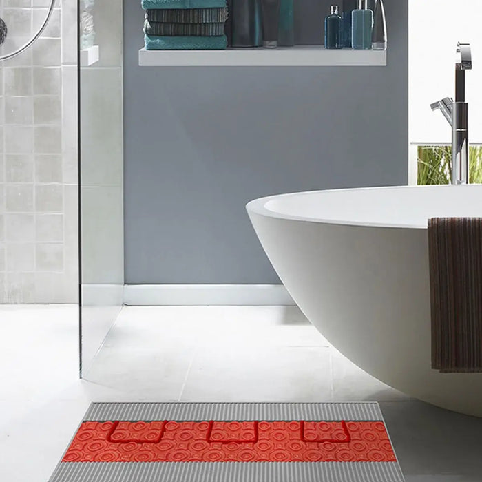 Underfloor heating membrane beneath large bathroom tiles for even warmth in a spa inspired space.