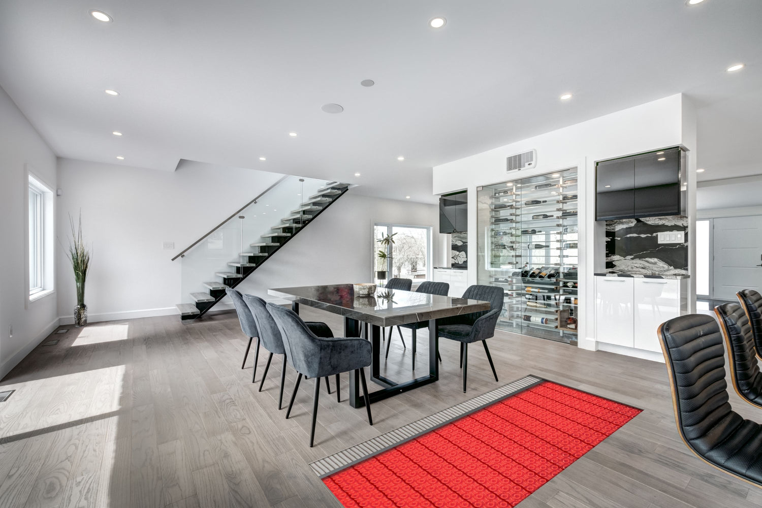 Red heating cables installed on top of tile underlayment membrane in a contemporary dining space with hardwood-look flooring.
