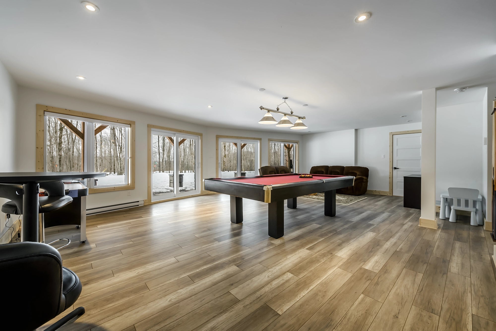 Spacious basement game room with billiard table and electric floor heating